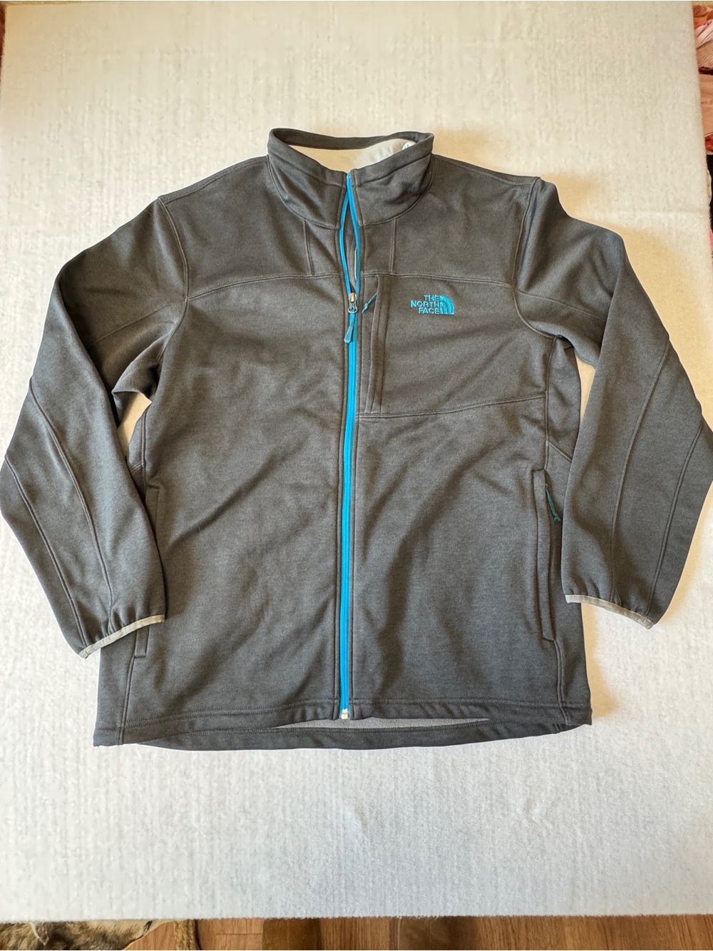 The North Face men’s Gray Fleece Jacket with Blue Trim